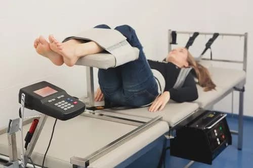 Patient having her back treated by a chiropractor